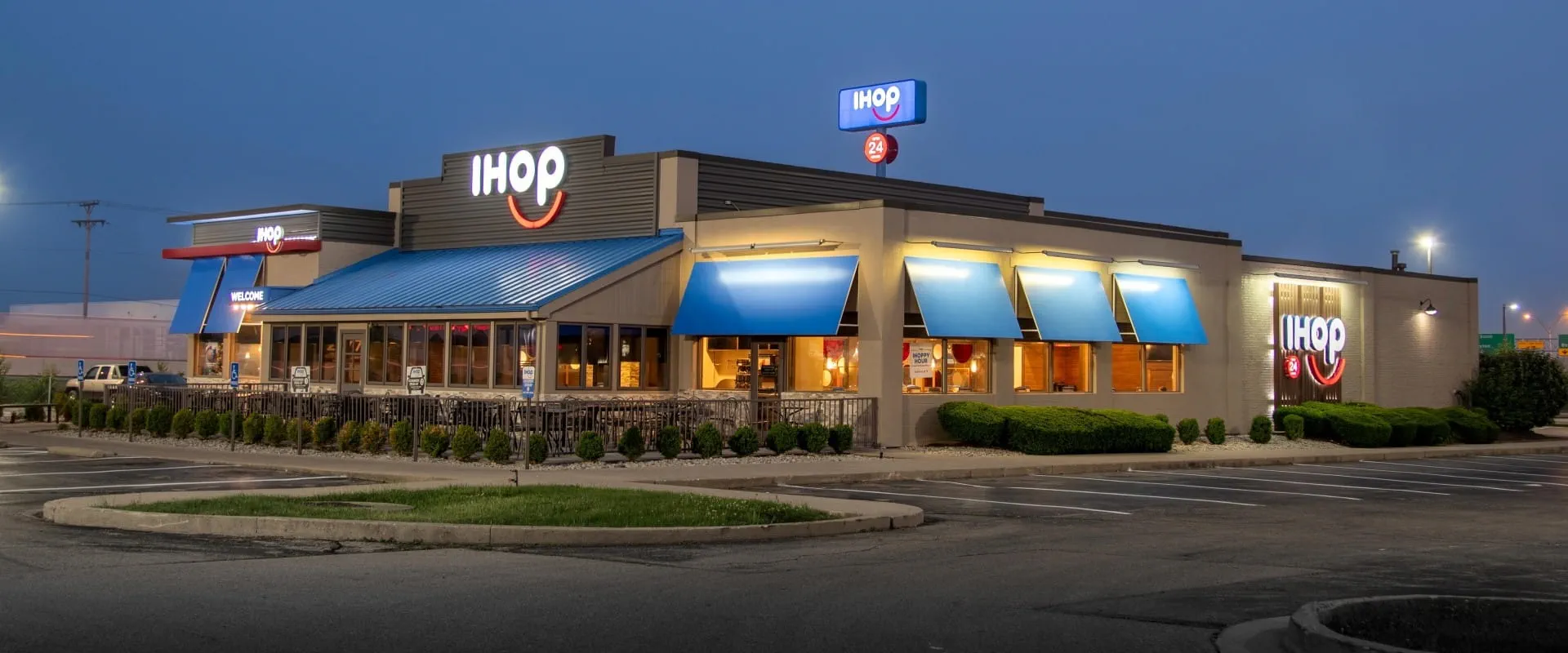 Exterior image of an IHOP building lit up at night